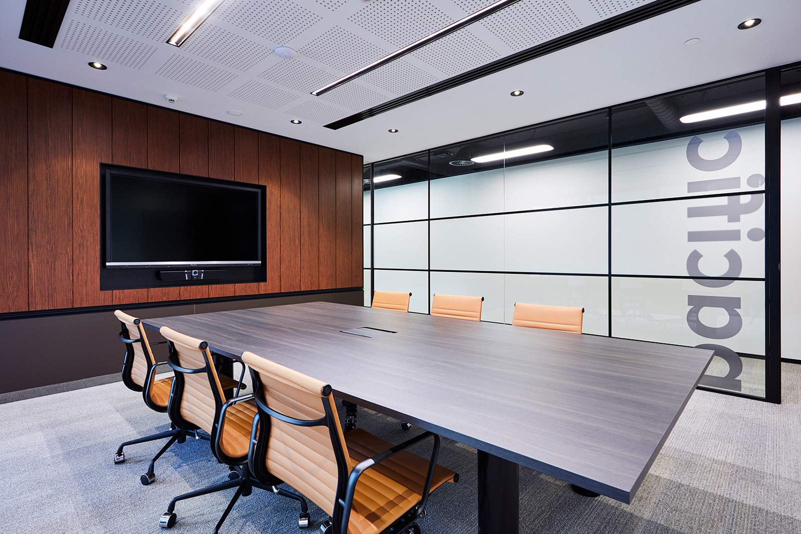 Boardroom with wall-mounted display and video bar